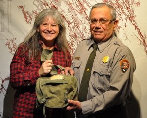 Rachel Cox Tso gives her pack to a ranger