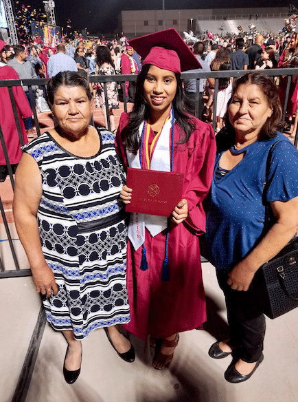 Kenia Guzman with family members at her AWC graduation.