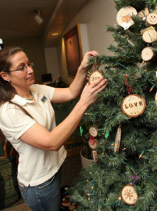 Cheryl Miller decorating a tree