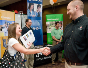 Student and career fair presenter shaking hands
