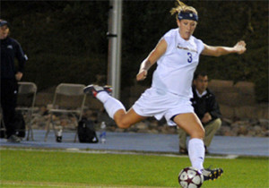 Kristi Anreasses kicking a soccer ball