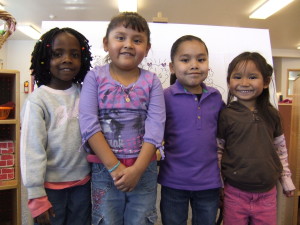 Four young English learners in a classroom