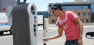 student uses a parking ticket machine