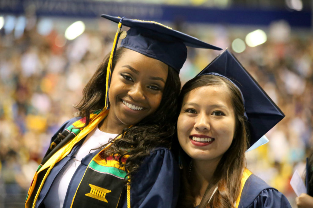 Two graduates during Spring 2016 commencement ceremony