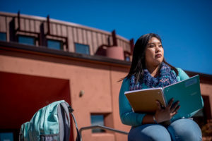 An NAU student studies outside of the Native American Cultural Center.