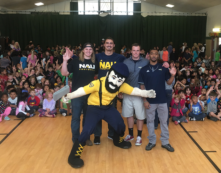 NAU student-athletes and Louie the Lumberjack join Flagstaff area elementary school students at an assembly.
