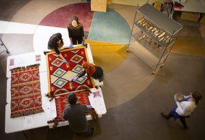 Students examine Navajo rug