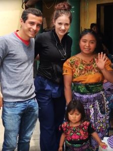 Nursing student poses with Guatemalan patients