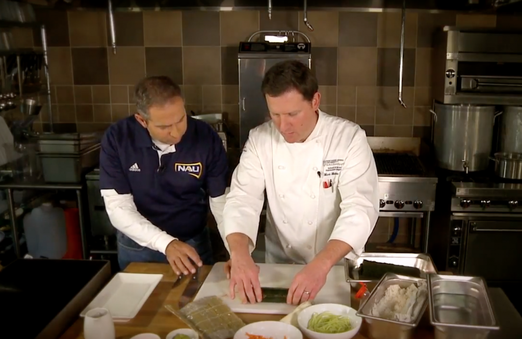 Mitch Strohman and Chef Mark Mulinaro roll sushi