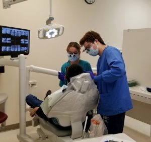 Britney White and Logan Toner providing dental cleaning at Hopi Health Care Center
