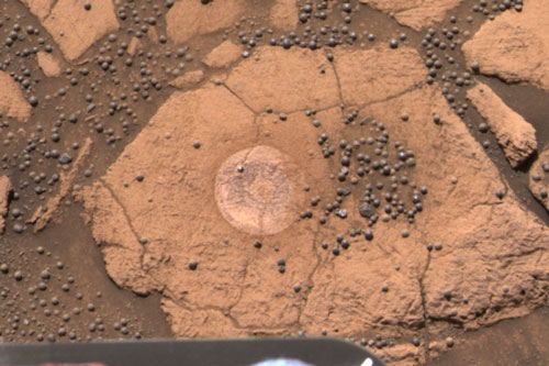 The rock known as "Berry Bowl" in Meridiani Planum, as imaged by the Pancam instrument on Opportunity's mast. Observations that both include and exclude these iron-oxide-bearing spherules were necessary to back out the composition of these individual components. Photo Credit: NASA/JPL/Cornell