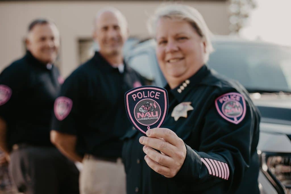 NAUPD officers hold pink patch