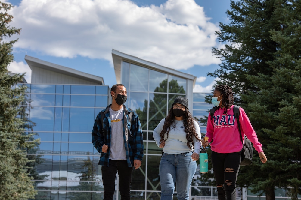 Masked students walk around campus