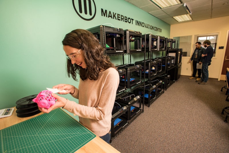 A woman works in the MakerLab at Cline Library.
