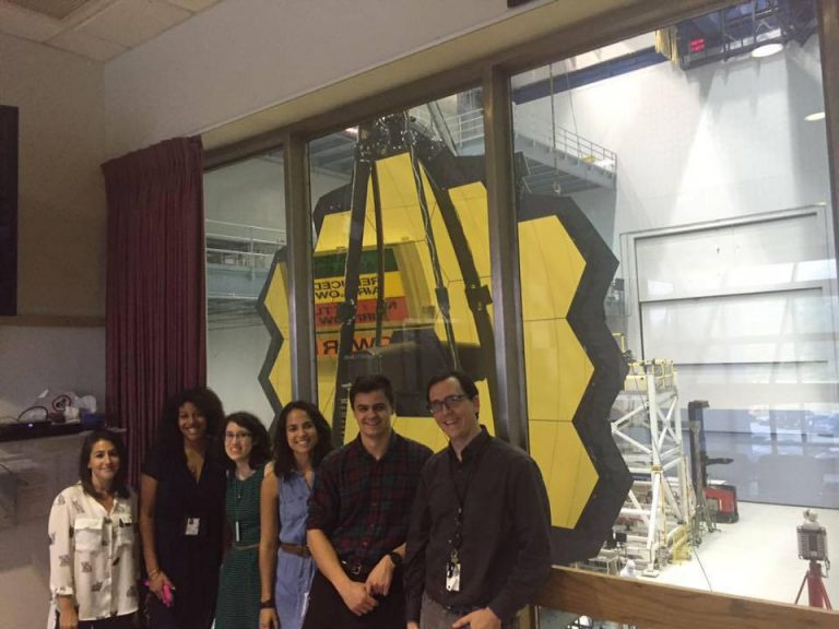 Amber Young in a group photo in front of JWST.