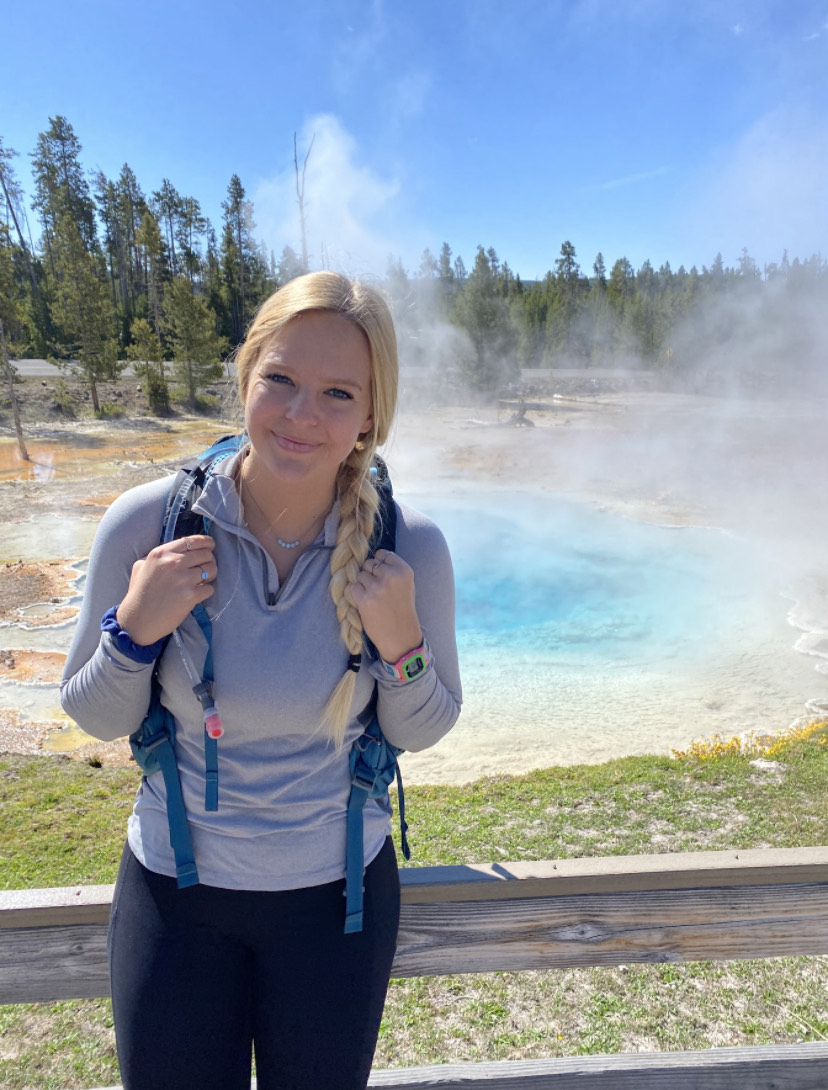 UCAN Health Coach Hannah Rahn in front of a geyser