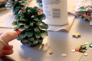Adding sequins to pinecone
