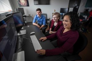 Cristina Thomas and two students at a computer
