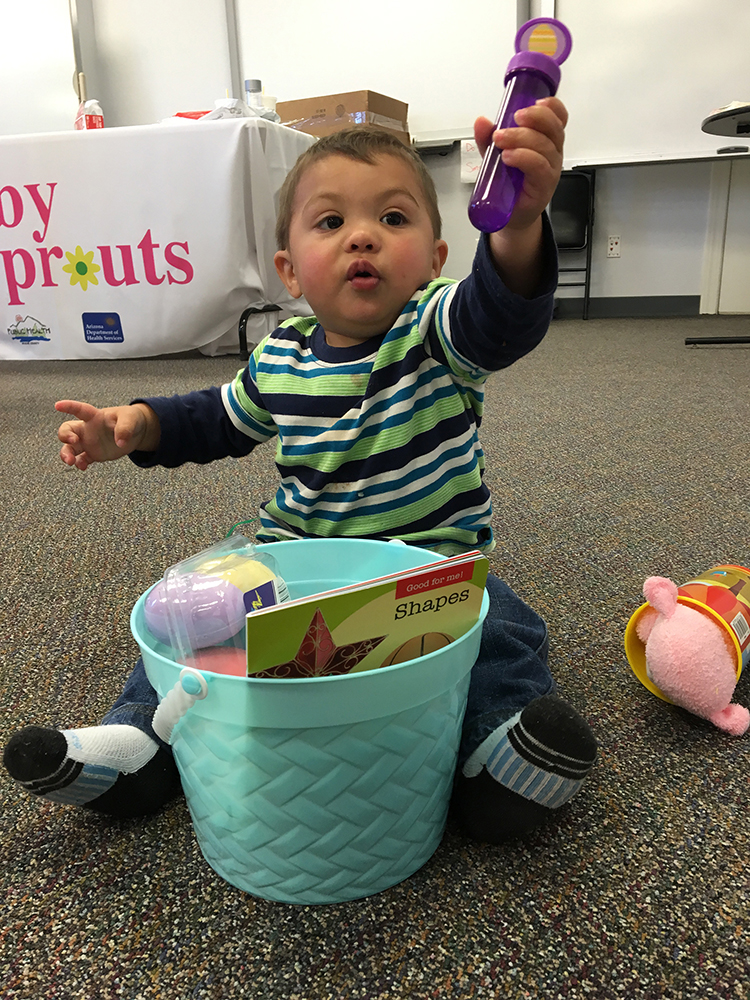 A child from Apache County plays with a basket from the Health Start program.