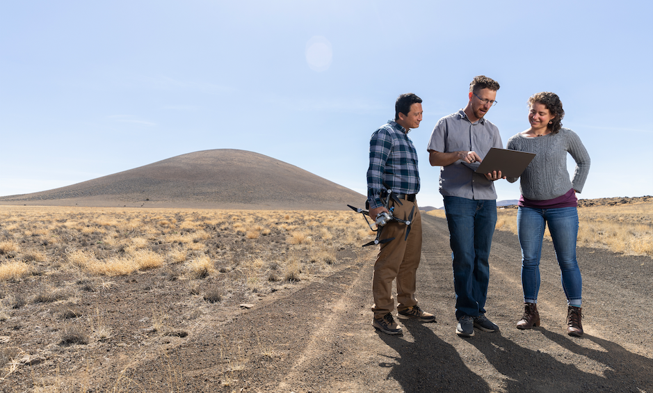 NAU researchers stand on desert dirt road