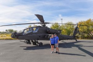 Amanda Nemec and husband in front of a Boeing helicopter