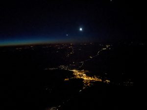 Venus, the crescent Moon, > Jupiter, and Mars over the signature sodium streetlights of Flagstaff.