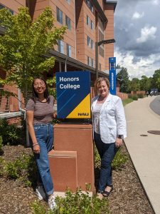 Beyoncé Bahe and Andrea Graves in front of the Honors College sign.