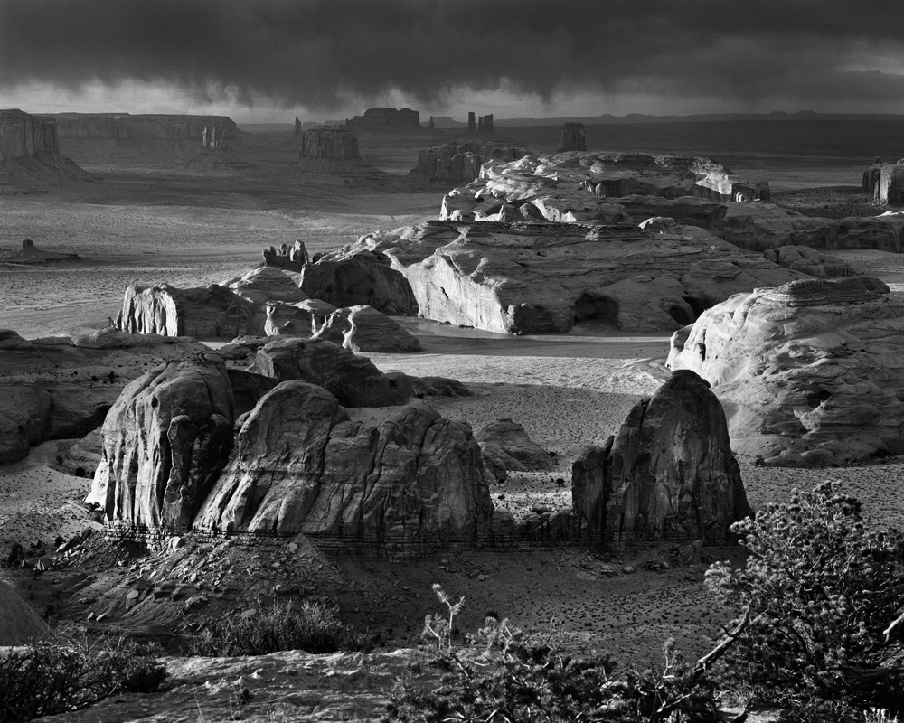 Photographer David Muench captured this dramatic view of Monument Valley Navajo Tribal Park from Hunts Mesa (image ca. 1960-1965). The park is located on the border of Arizona and Utah within the Navajo Nation. 