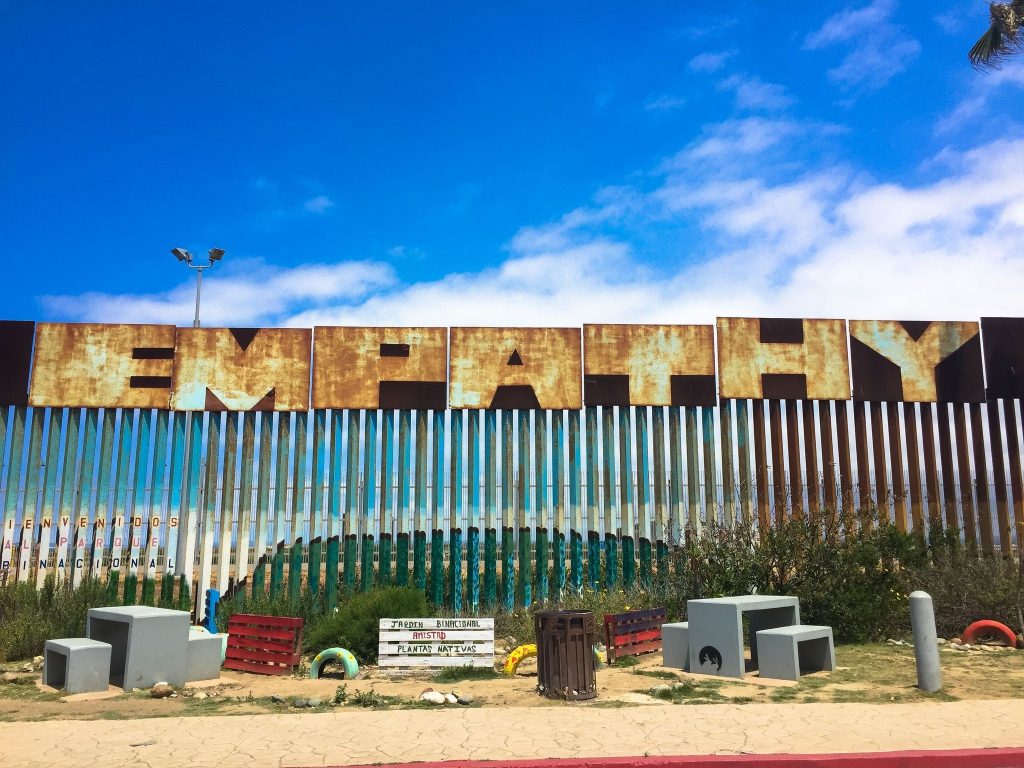 The word "empathy" written on the southern border wall
