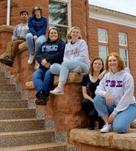 Several women from a band sorority in front of Old Main