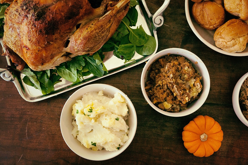 Mashed potatoes, stuffing and a turkey on the Thanksgiving table