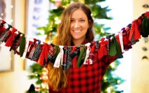 Woman holds up holiday garland