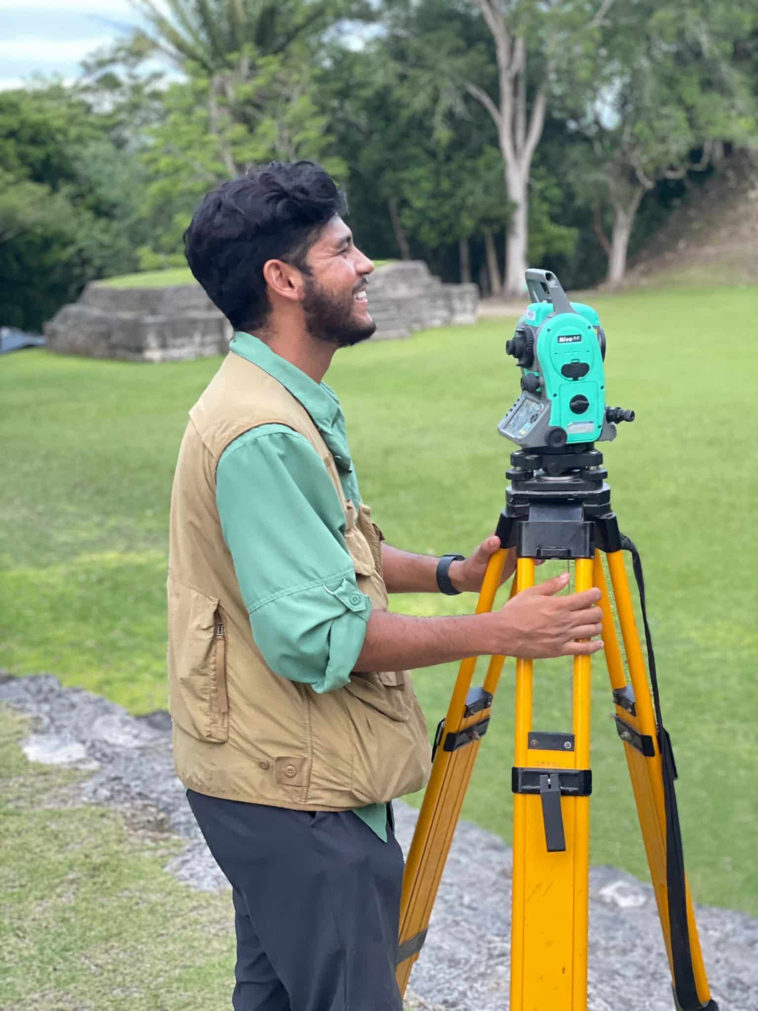 Estevan Ramirez using survey equipment in Belize