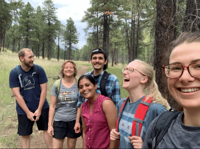 Laura Wasylenki in the forest with five students