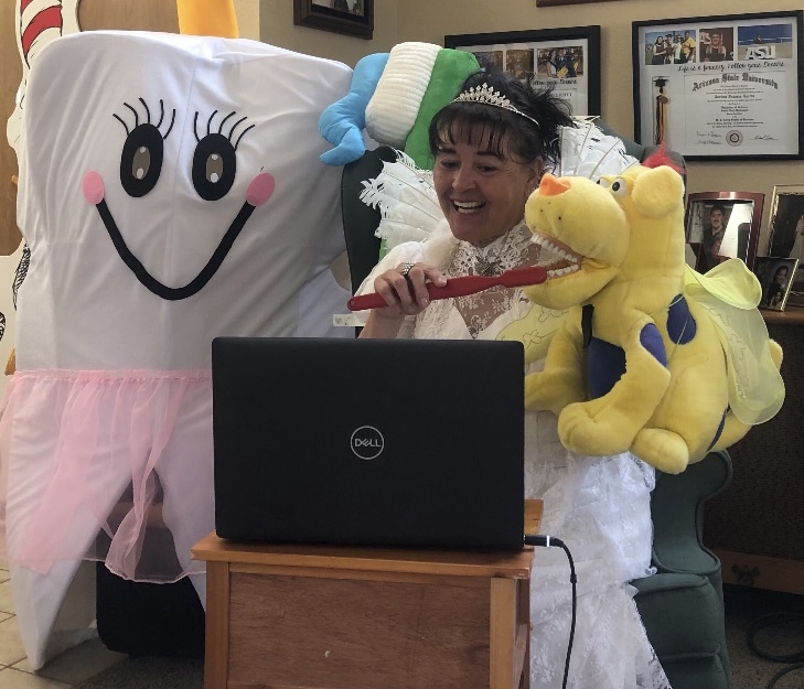 Jenny Zamora-Garcia in her tooth fairy costume with a life-size tooth