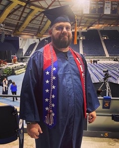 Matthew Traylor in graduation robes