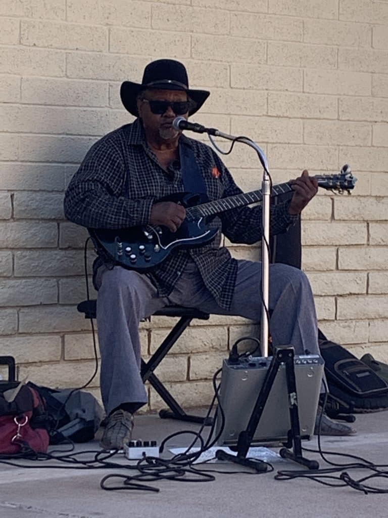 Intern Ivan Pacheco captured blues guitarist Tommie Dukes playing solo at the corner of 2nd St. (old Route 66) and Kinsley Avenue in Winslow. (PHOTO: NAU.PH.2022.03.03.02)