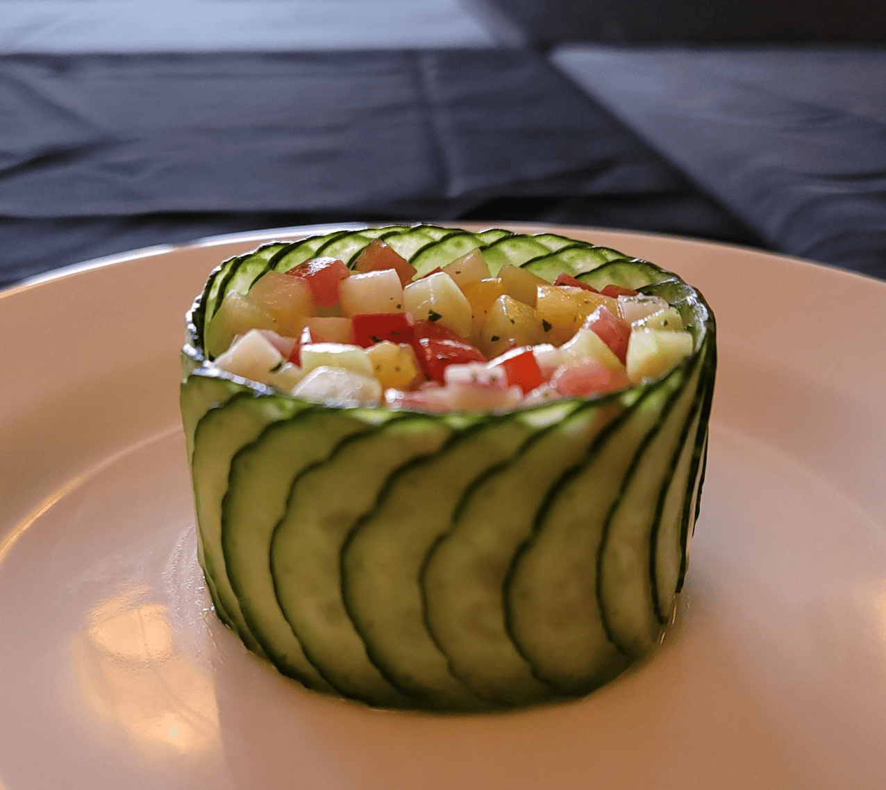 haute-couture salad which is thinly sliced cucumber wrapper around to hold the salad inside.