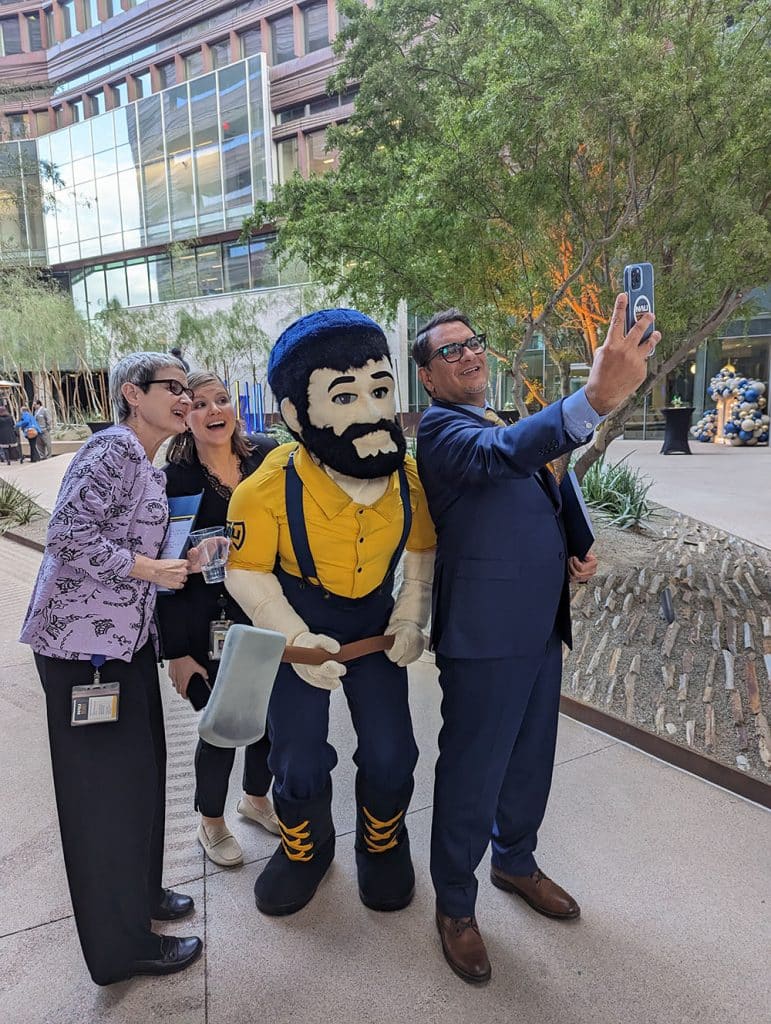 President Cruz Rivera, Louie the Lumberjack and others pose for a selfie.