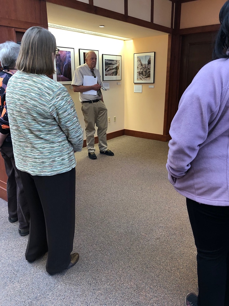 Hank Hassell talks to a group of visitors at Cline Library