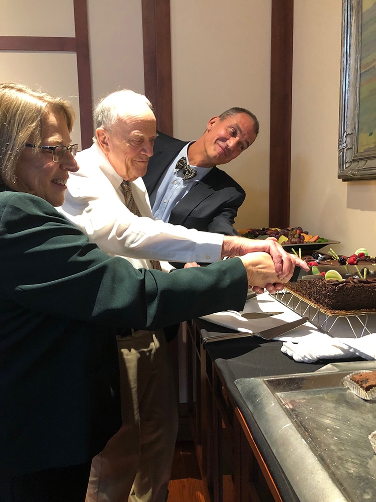 Hank Hassell, Cynthia Childrey and Peter Runge cut the cake at the opening of the Lost World exhibit
