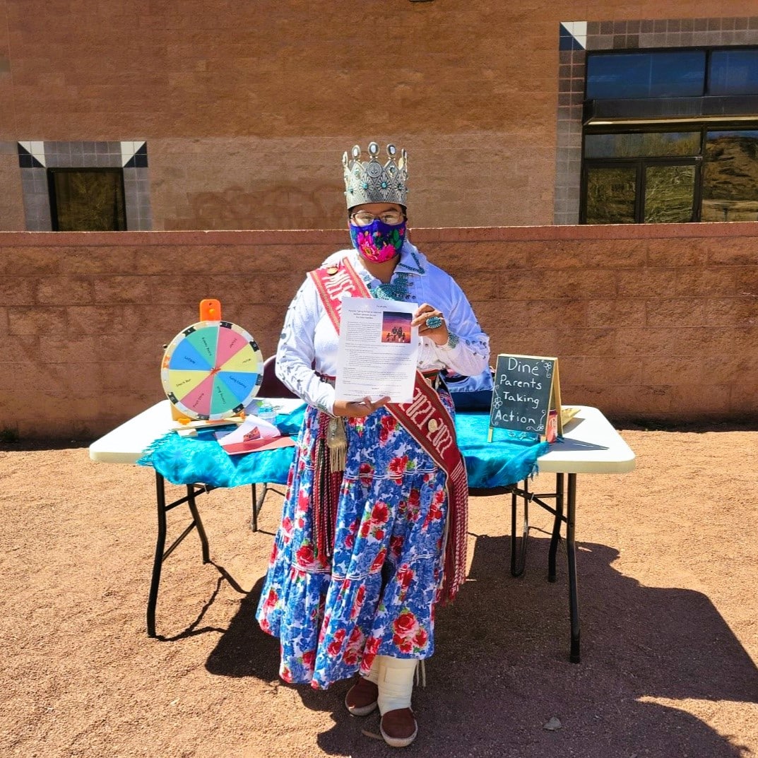 This is a picture of Ms. Navajo Nation in 2022 at the week of the Young Child in Window Rock holding up a flyer for the project.