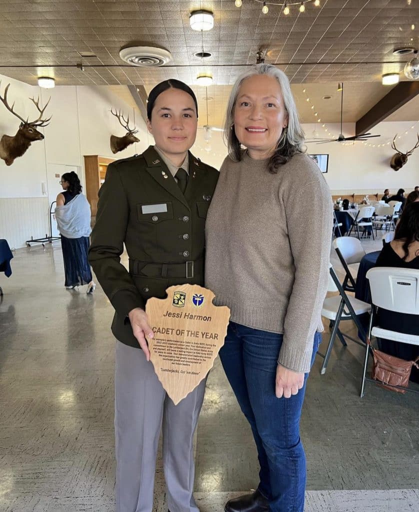 Harmon holding her Cadet of the Year plaque with her mother