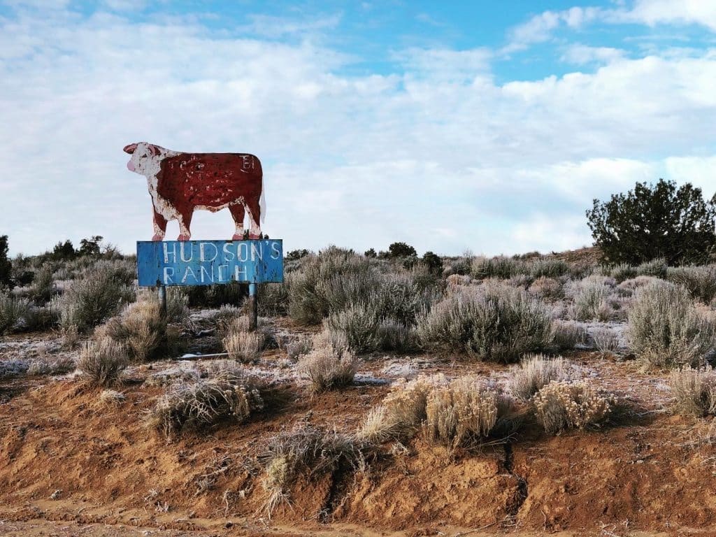 Picture of Hudson Ranch outside of Gallup, New Mexico with a cow sign