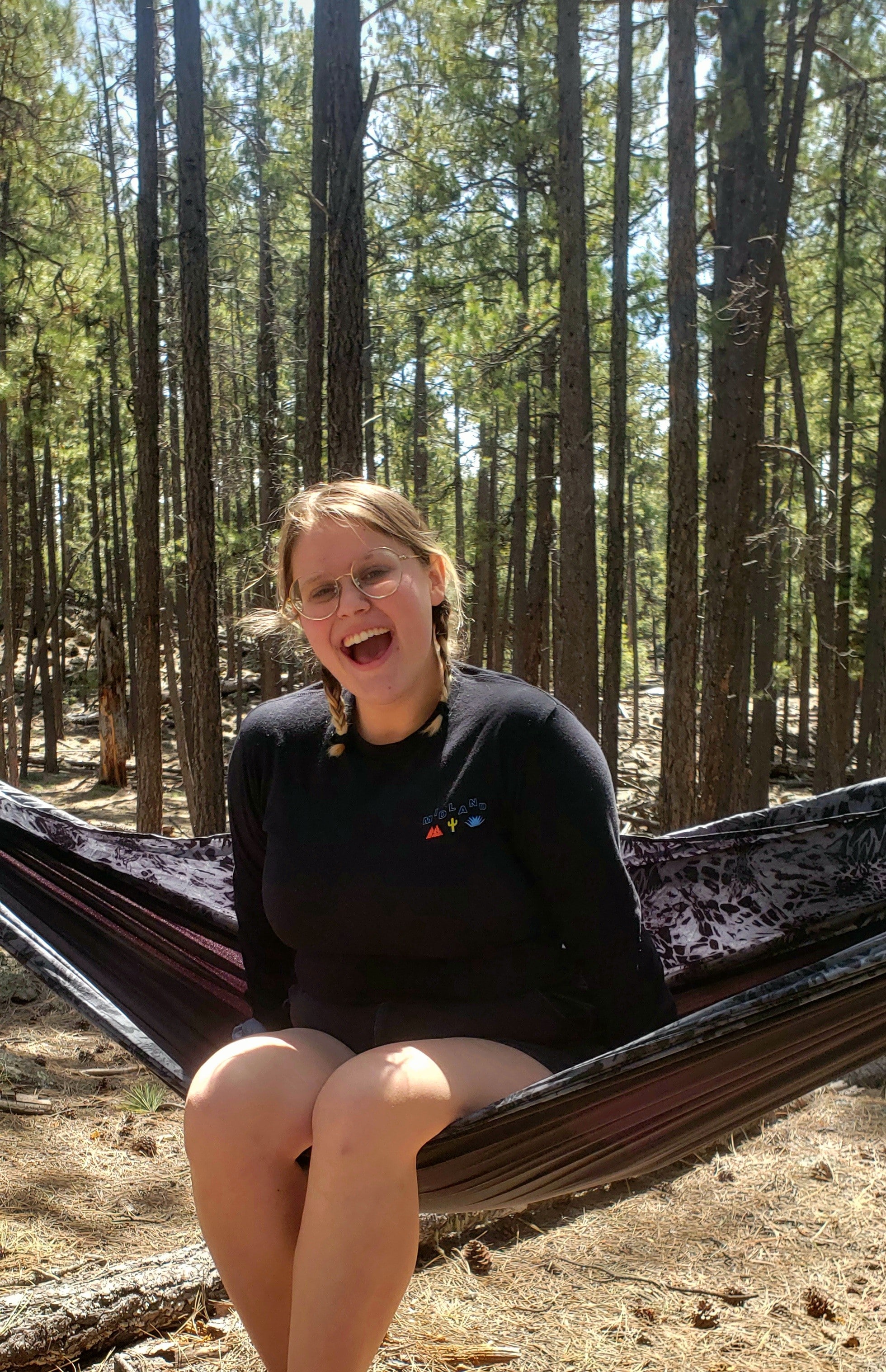 Rebekah Wucinich sitting in a hammock with the forest behind her