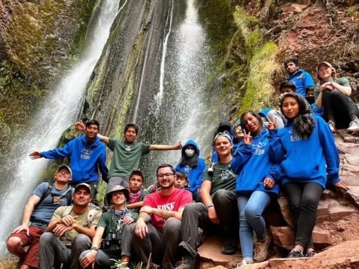 A group of students in front of a waterfall in Peru