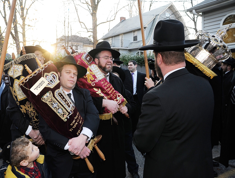 Jews getting a new Torah walk to the synagogue