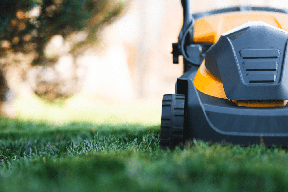 An electric lawnmower on green grass