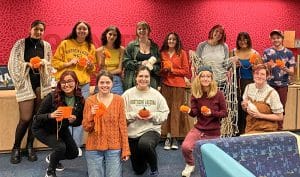 Members of the Lumberjack Fiber Crafts Club show their knitted pumpkins and other projects.