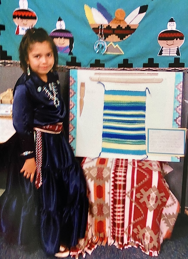 Young Kaylin with a rug she knitted.